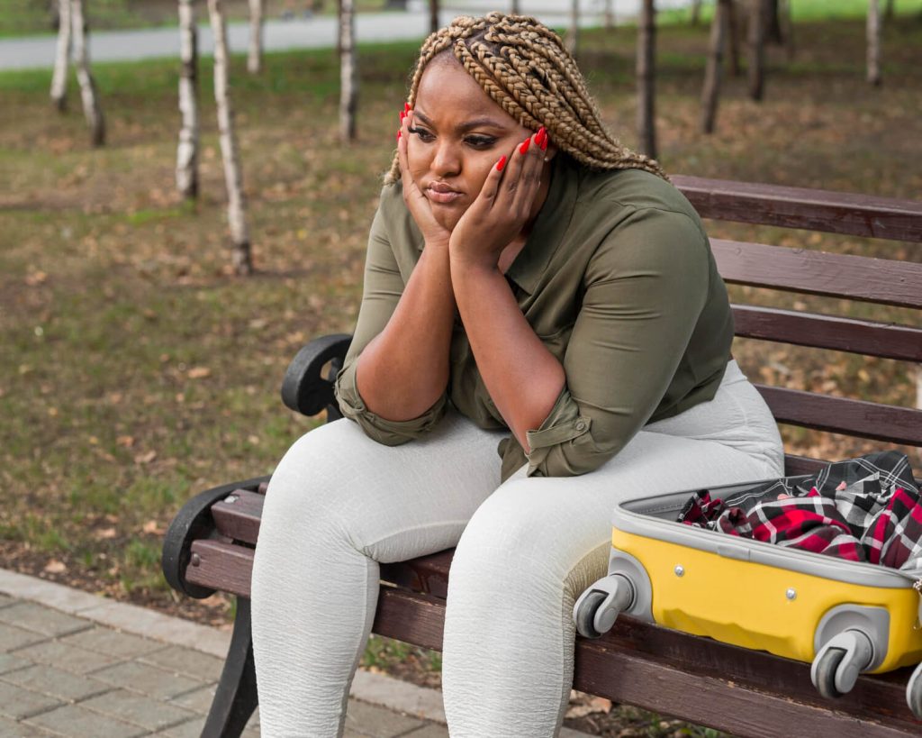 a lady sitting on a bench unable to decide what she wants with herself suggesting indecision