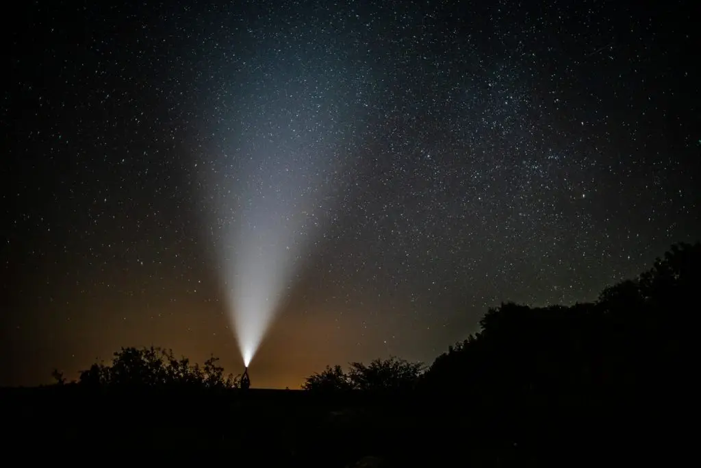 a single point of light on a dark starry night