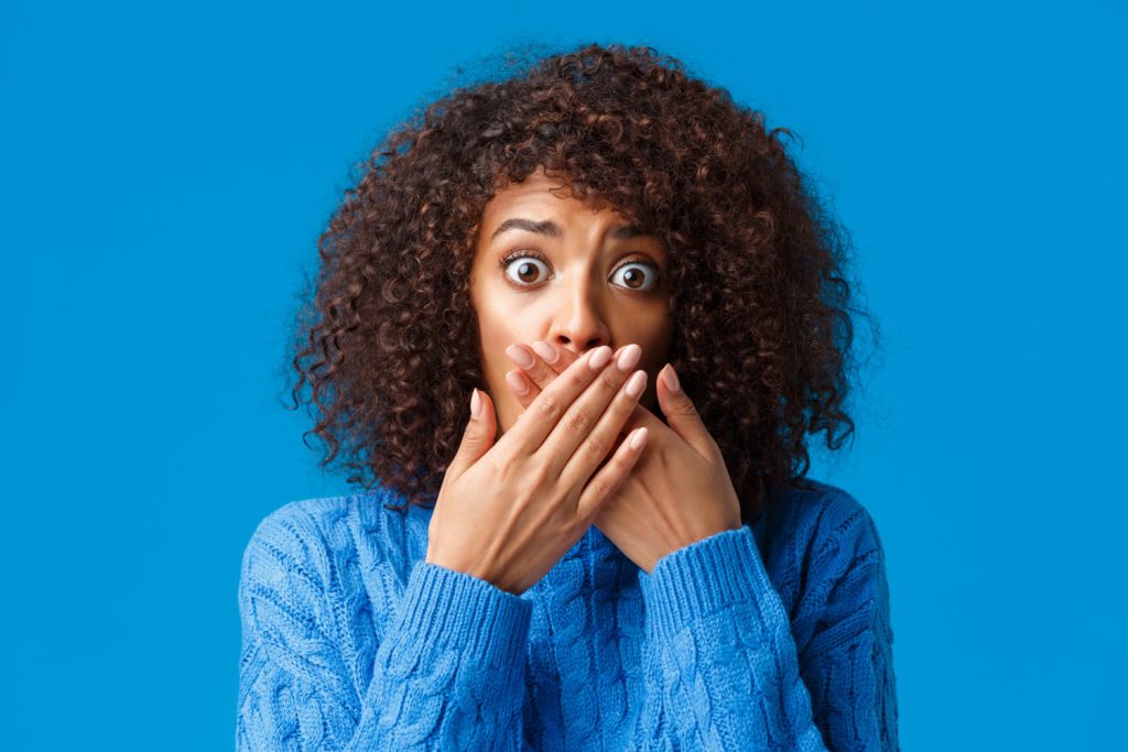 woman in blue expressing shock over her fear of judgment because she does not dare to be different