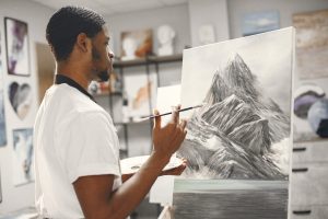 artist drawing happily after overcoming creative block